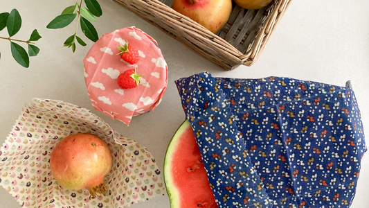 Colorful beeswax wraps covering fruit and bread, showcasing eco-friendly alternatives for sustainable living in the UK.