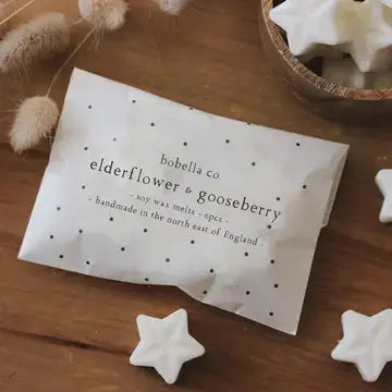 Elderflower & Gooseberry Soy Wax Melts by Bobella Co. in star shapes, hand-poured and renewably sourced, pack of 6 on wooden table.